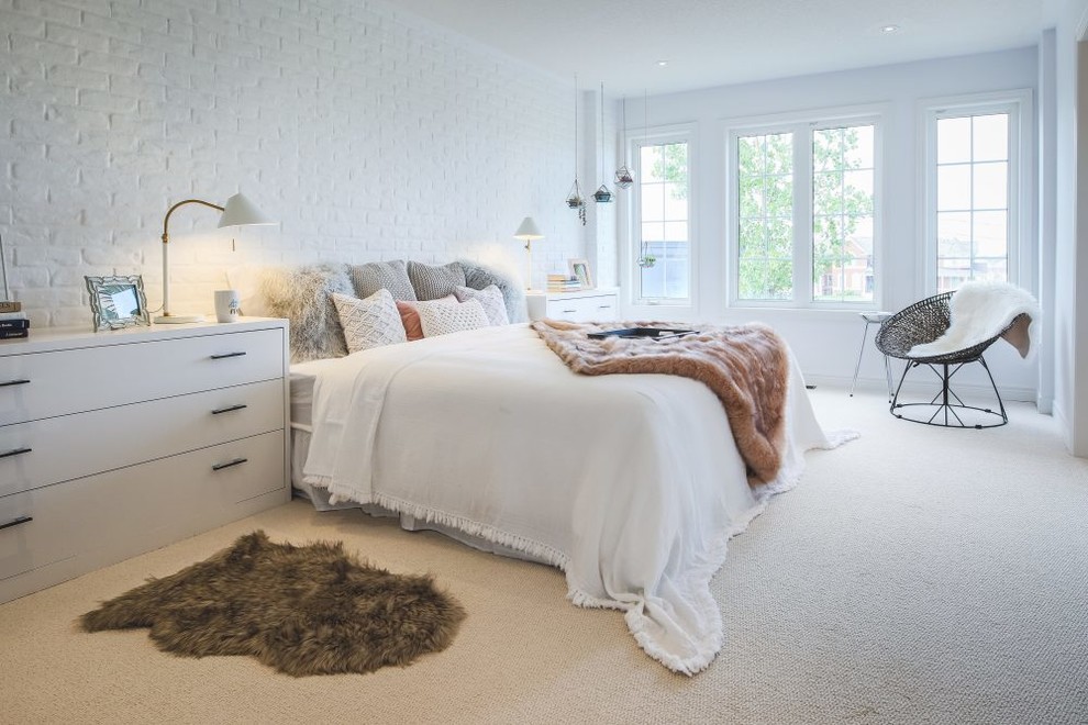 Inspiration for a mid-sized scandinavian master bedroom in Toronto with white walls and carpet.