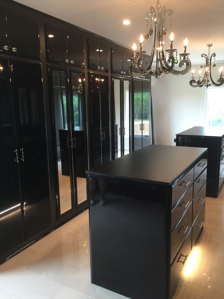 This is an example of a large modern women's walk-in wardrobe in Nashville with flat-panel cabinets, black cabinets and porcelain floors.
