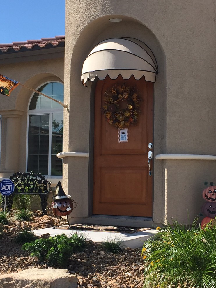 Inspiration for a mid-sized transitional concrete floor entryway remodel in Other with a medium wood front door