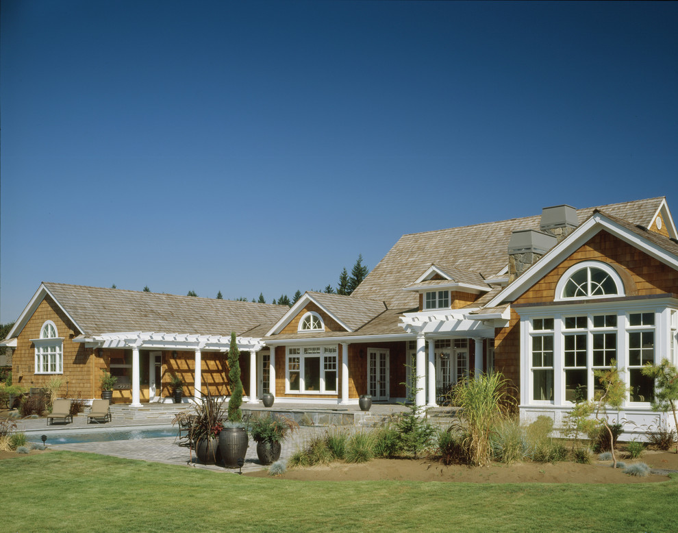 This is an example of a mid-sized traditional one-storey exterior in Portland with wood siding.