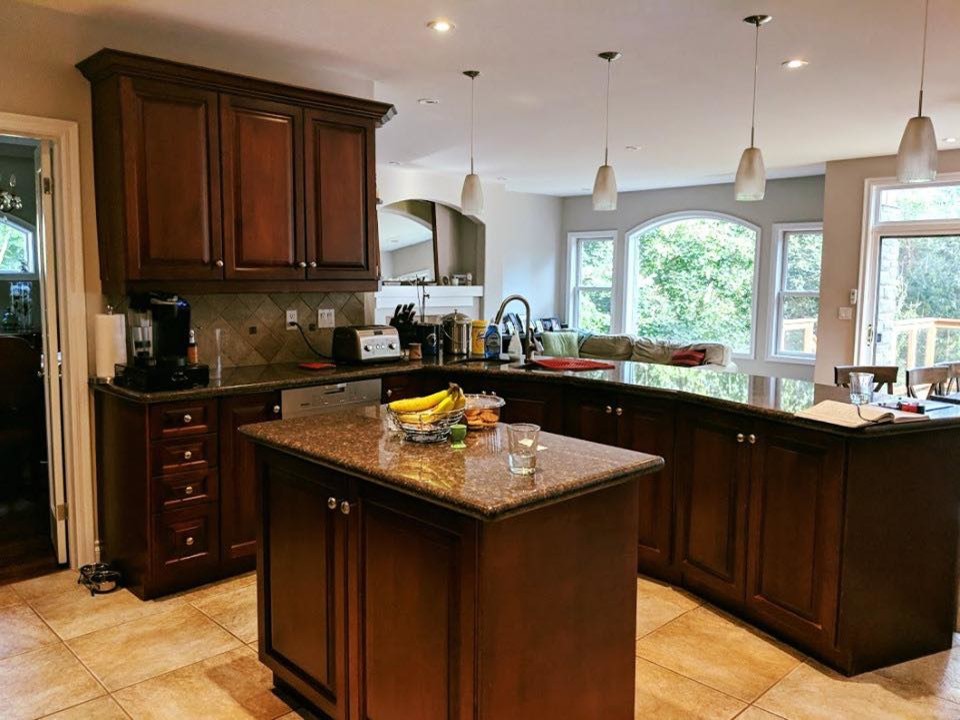 Inspiration for a transitional kitchen remodel in Toronto with quartzite countertops and an island