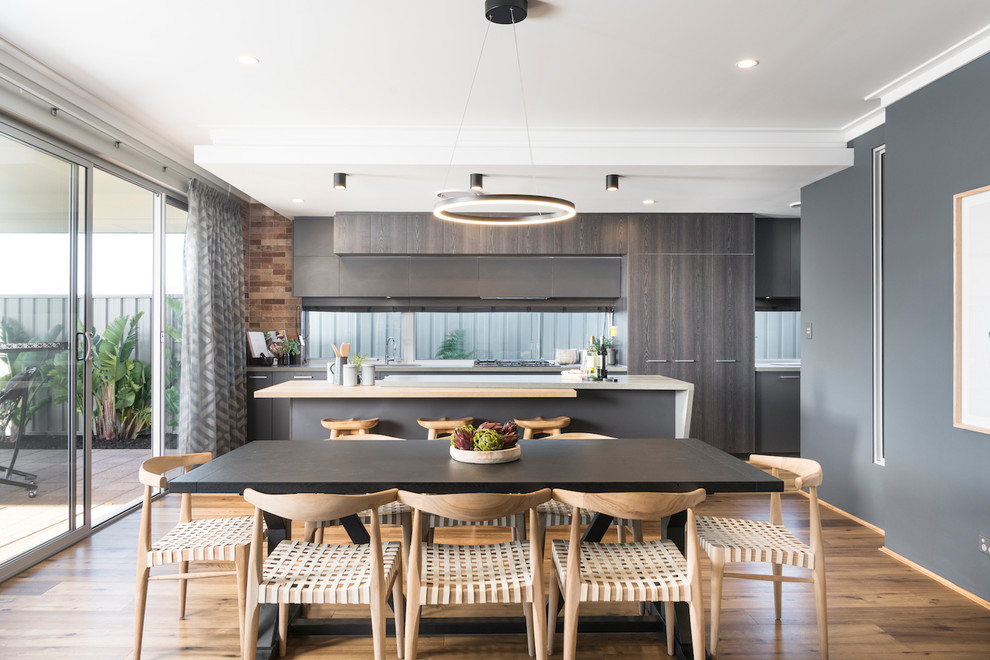 Photo of a contemporary kitchen/dining combo in Perth with grey walls and light hardwood floors.