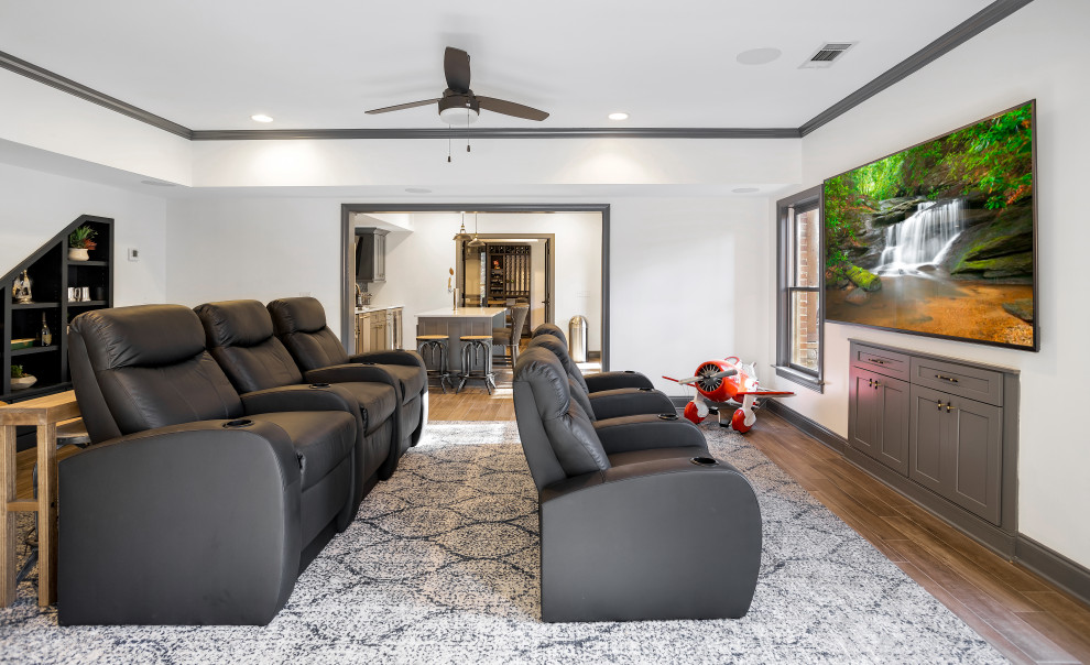 Design ideas for a large transitional open concept home theatre in Atlanta with white walls, porcelain floors, brown floor and a wall-mounted tv.