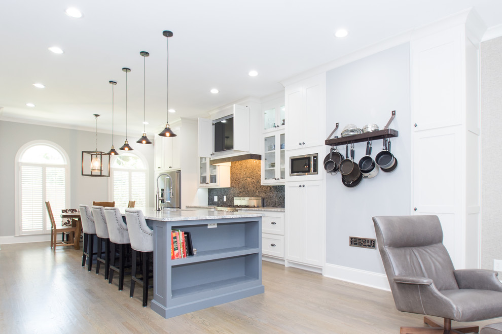Large transitional galley light wood floor eat-in kitchen photo in Atlanta with an undermount sink, shaker cabinets, white cabinets, quartzite countertops, multicolored backsplash, stone tile backsplash, stainless steel appliances and an island