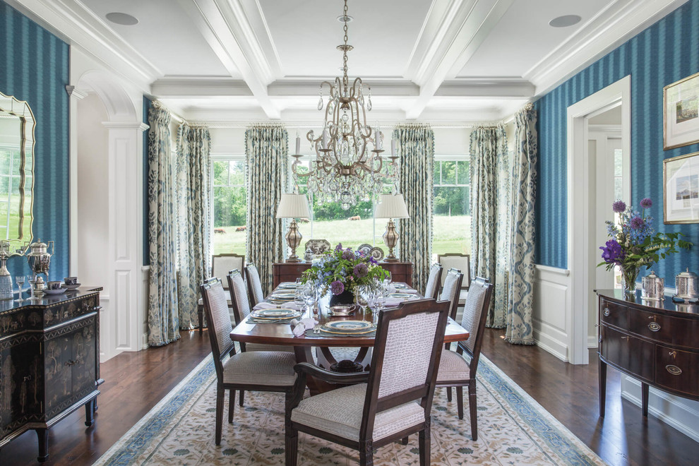 Photo of a large traditional separate dining room with blue walls, dark hardwood floors, no fireplace and brown floor.