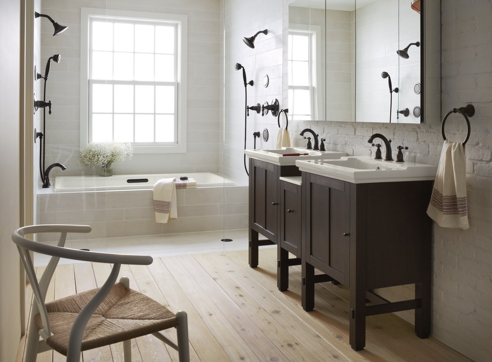 Design ideas for a mid-sized transitional master bathroom in Milwaukee with an integrated sink, shaker cabinets, dark wood cabinets, solid surface benchtops, an alcove tub, an open shower, beige tile, white walls and light hardwood floors.