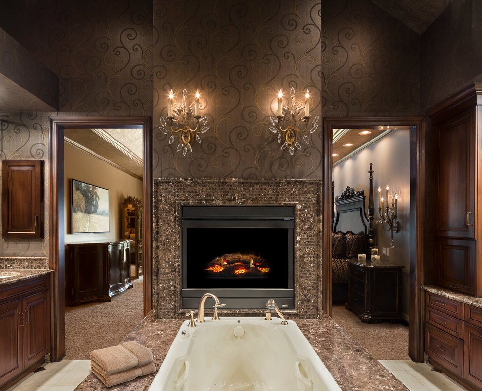 Inspiration for a large traditional master bathroom in Kansas City with marble benchtops, a freestanding tub, a double shower, brown tile, stone slab, brown walls, travertine floors, an undermount sink, beaded inset cabinets and medium wood cabinets.