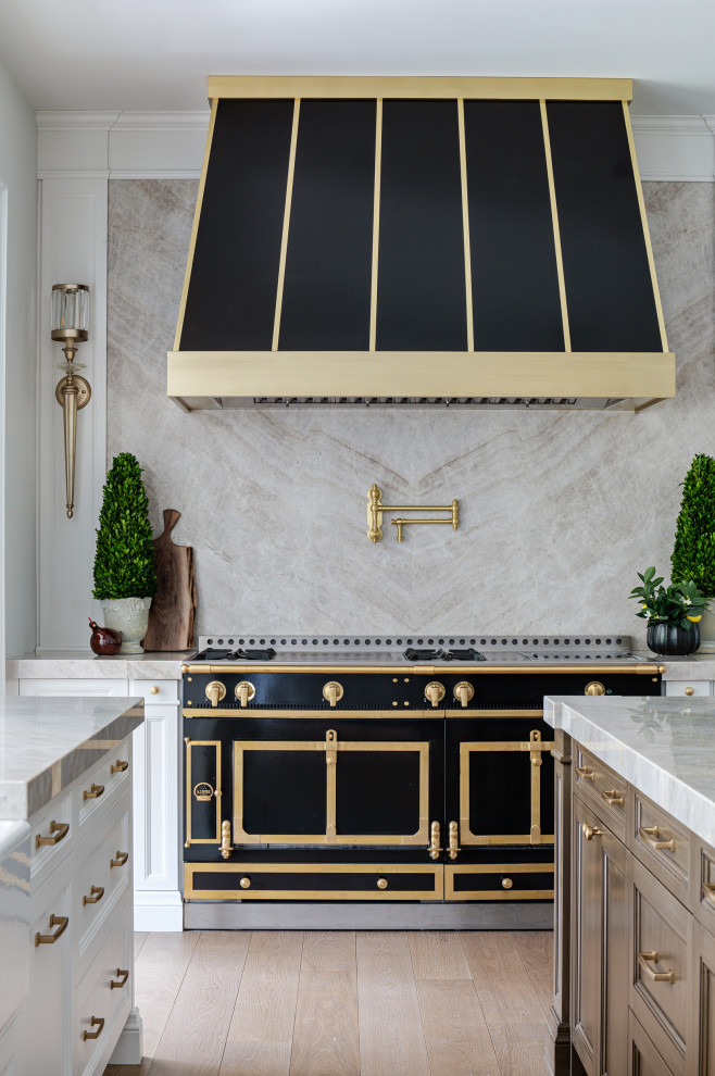Inspiration for a transitional light wood floor kitchen remodel in Toronto with black appliances