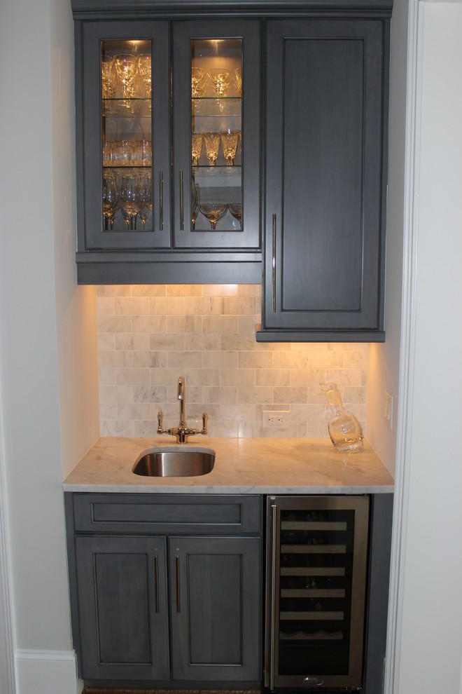 Inspiration for a small transitional single-wall wet bar in Miami with an undermount sink, shaker cabinets, grey cabinets, marble benchtops, grey splashback, marble splashback, dark hardwood floors and brown floor.