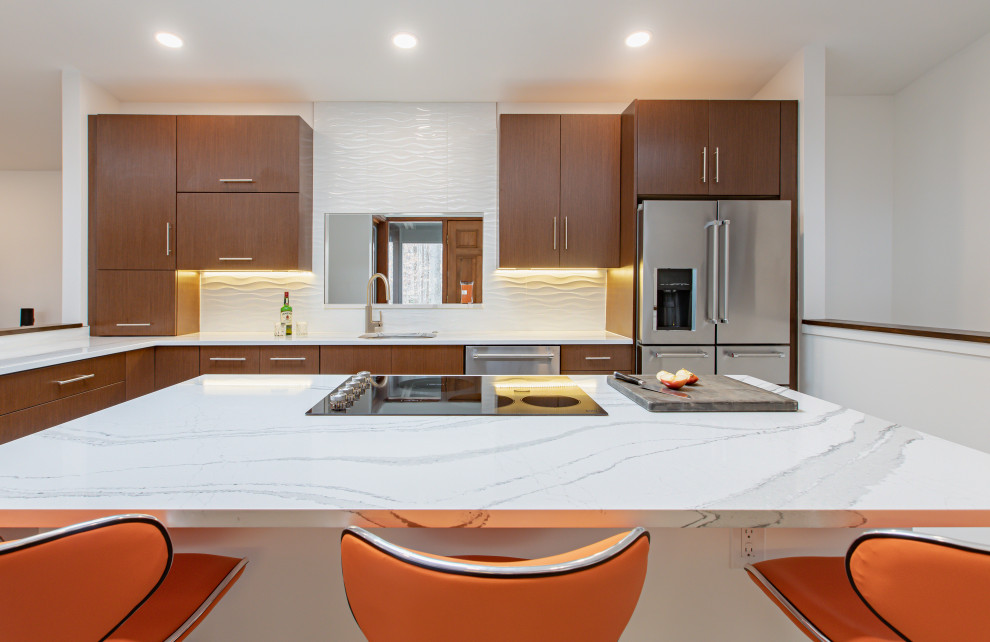 This is an example of a large contemporary u-shaped kitchen pantry in DC Metro with an undermount sink, flat-panel cabinets, medium wood cabinets, quartz benchtops, white splashback, ceramic splashback, stainless steel appliances, porcelain floors, with island, beige floor and white benchtop.