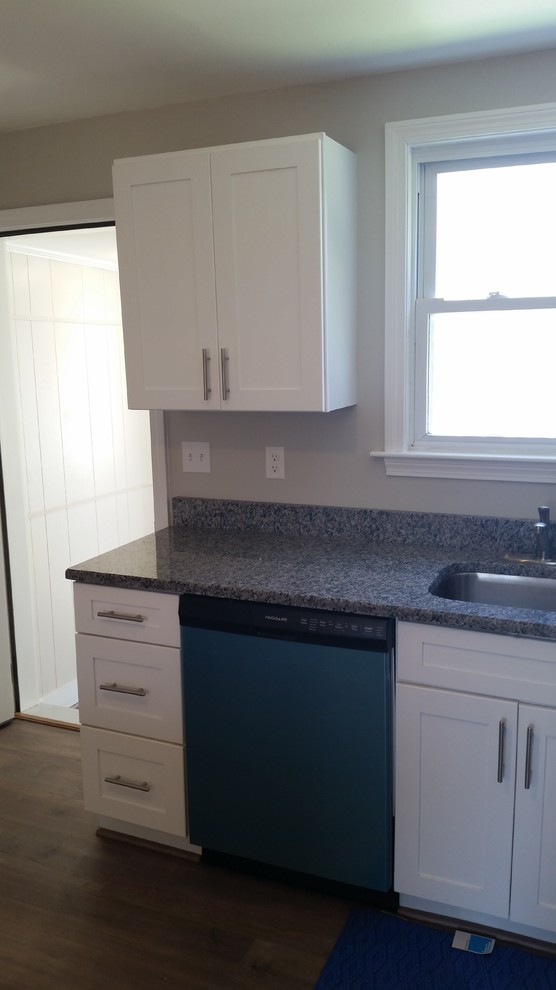 Home design - mid-sized transitional l-shaped home design idea in Providence with a single-bowl sink, shaker cabinets, white cabinets, granite countertops, stainless steel appliances and a peninsula