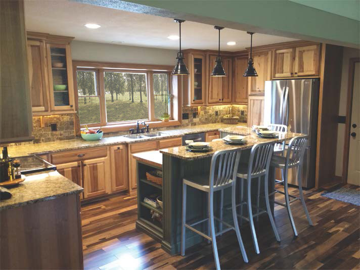 Kitchen - large rustic u-shaped medium tone wood floor kitchen idea with an undermount sink, raised-panel cabinets, medium tone wood cabinets, granite countertops, multicolored backsplash, stone tile backsplash, stainless steel appliances and an island