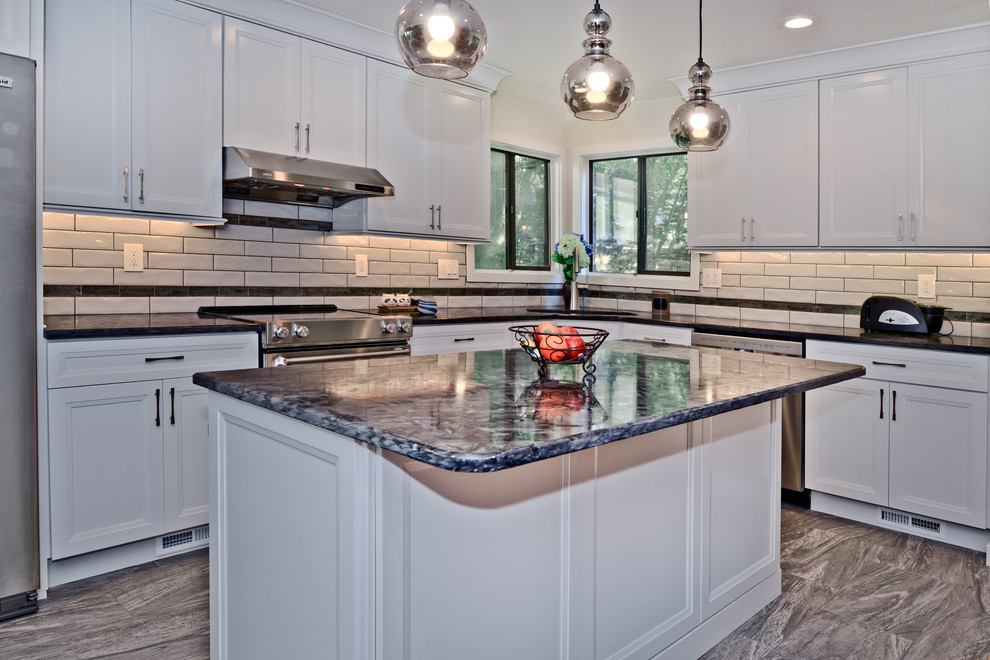 Photo of a mid-sized contemporary eat-in kitchen in DC Metro with flat-panel cabinets, white cabinets, granite benchtops, white splashback, stainless steel appliances, with island, grey floor and grey benchtop.