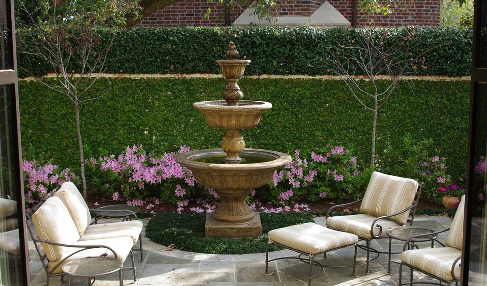Inspiration for a small traditional backyard patio in Houston with a water feature, tile and no cover.
