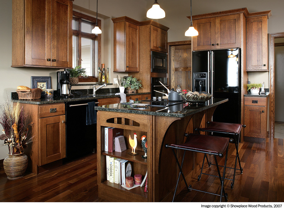 Traditional kitchen in Other with black appliances.