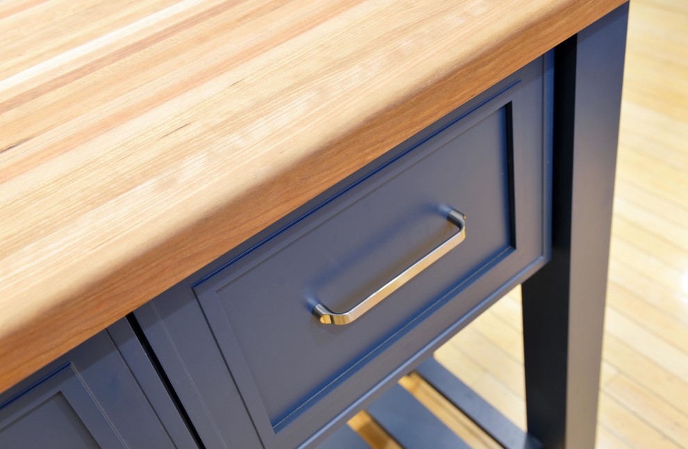 Home design - mid-sized transitional light wood floor and brown floor home design idea with a farmhouse sink, shaker cabinets, gray cabinets, wood countertops, white backsplash, porcelain backsplash, stainless steel appliances, an island and brown countertops