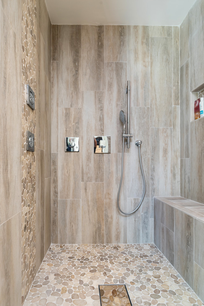 Inspiration for a mid-sized contemporary master bathroom in San Francisco with flat-panel cabinets, dark wood cabinets, an alcove shower, beige tile, porcelain tile, beige walls, porcelain floors, an undermount sink, solid surface benchtops, beige floor and a hinged shower door.