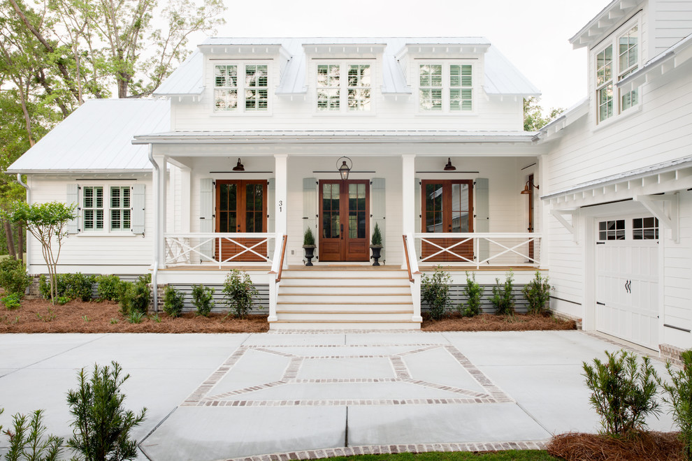 Inspiration for a country two-storey white house exterior in Charleston with wood siding, a metal roof and a white roof.