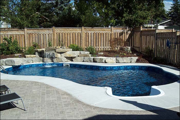 Pool - mid-sized transitional backyard custom-shaped and concrete paver lap pool idea in Toronto