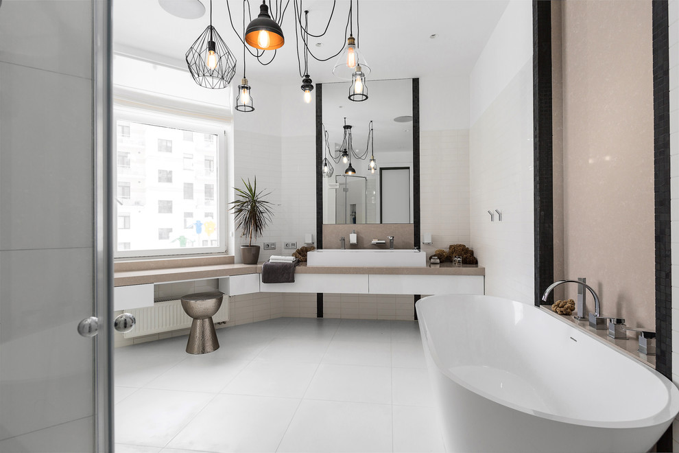 Contemporary master bathroom in Saint Petersburg with flat-panel cabinets, white cabinets, a freestanding tub, white tile, white walls and a trough sink.