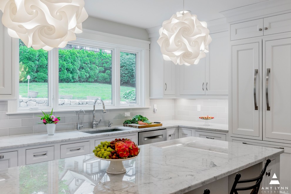 Example of a mid-sized transitional l-shaped medium tone wood floor and red floor eat-in kitchen design in Boston with an undermount sink, beaded inset cabinets, white cabinets, marble countertops, gray backsplash, porcelain backsplash, paneled appliances, an island and yellow countertops