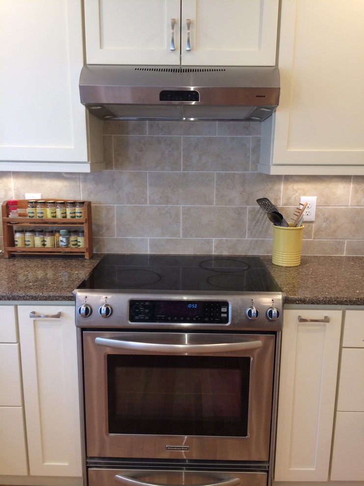 Kitchen - kitchen idea in Denver with recessed-panel cabinets, white cabinets, gray backsplash and stainless steel appliances