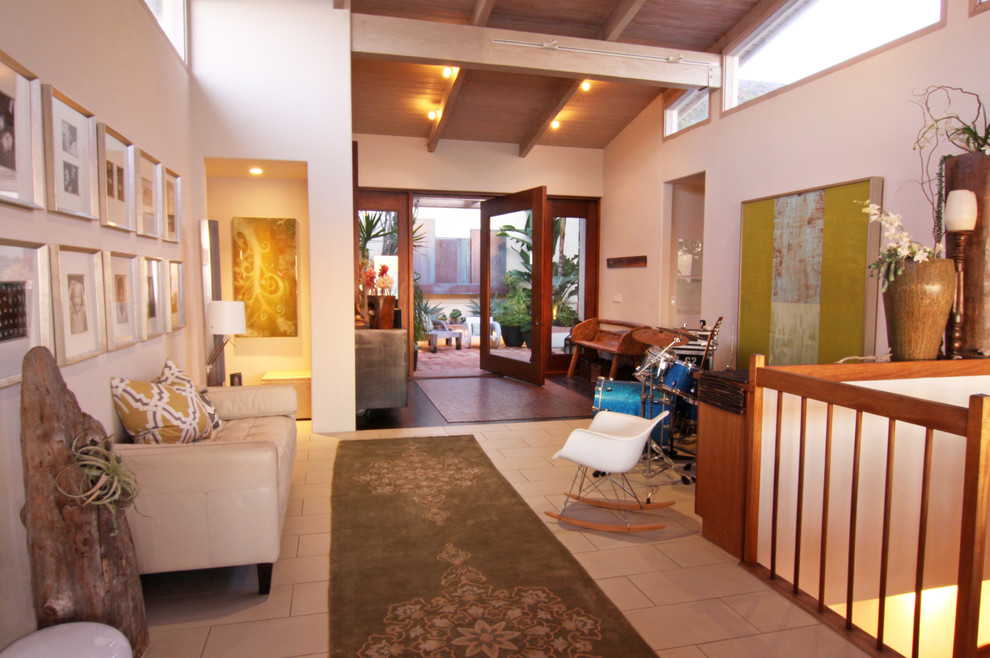 Eclectic entryway in San Diego with white walls.