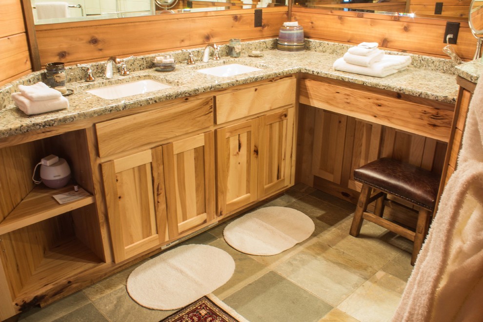 Mid-sized mountain style l-shaped slate floor and gray floor eat-in kitchen photo with flat-panel cabinets, medium tone wood cabinets, an undermount sink, granite countertops, stainless steel appliances and an island