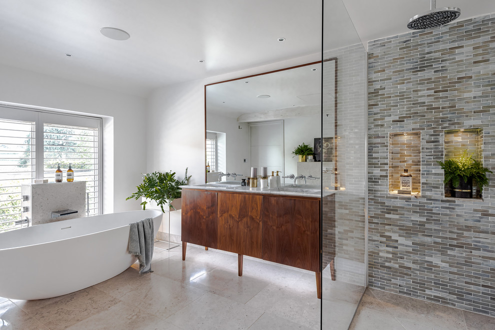 Photo of a contemporary master bathroom in Other with flat-panel cabinets, medium wood cabinets, a freestanding tub, a curbless shower, white walls, an undermount sink, beige floor and an open shower.