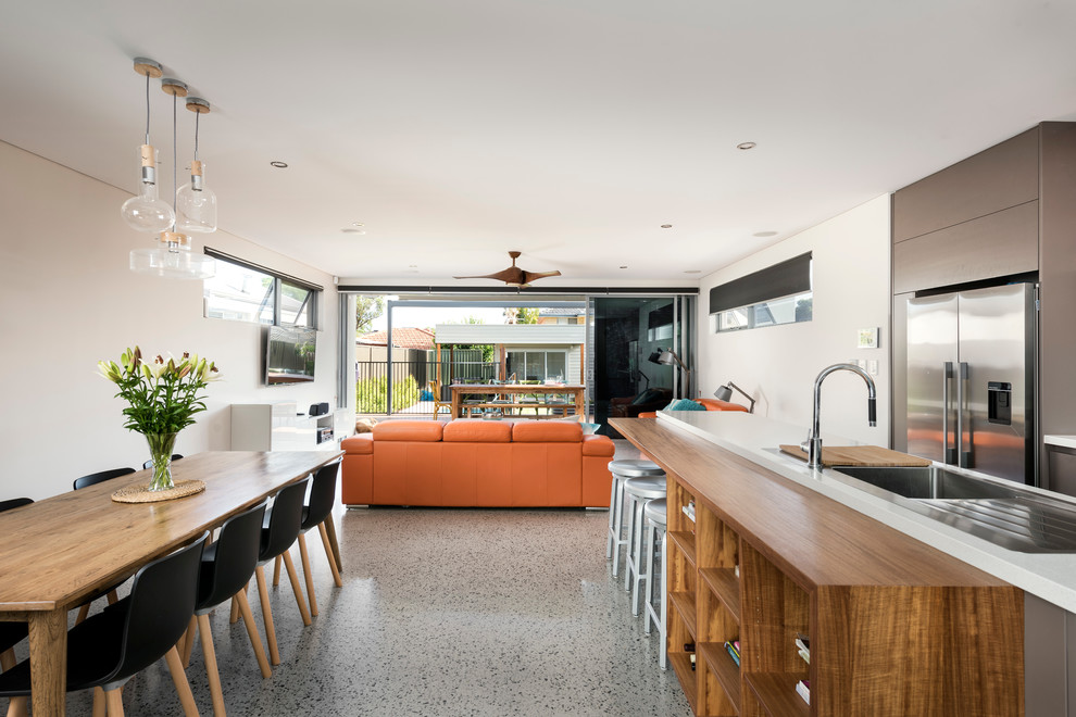 Photo of a mid-sized contemporary galley eat-in kitchen in Perth with an undermount sink, quartz benchtops, glass sheet splashback, stainless steel appliances, concrete floors and with island.