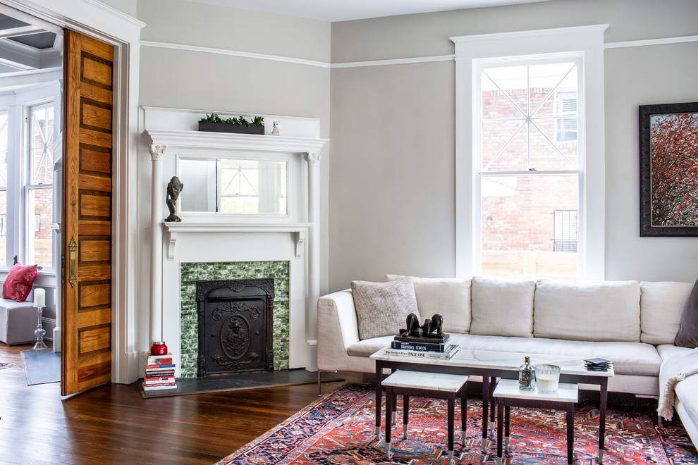 Example of a transitional enclosed dark wood floor and brown floor living room design in Atlanta with gray walls and a corner fireplace