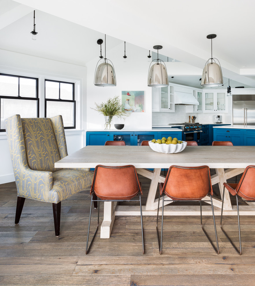 Inspiration for a beach style open plan dining in Seattle with white walls and light hardwood floors.