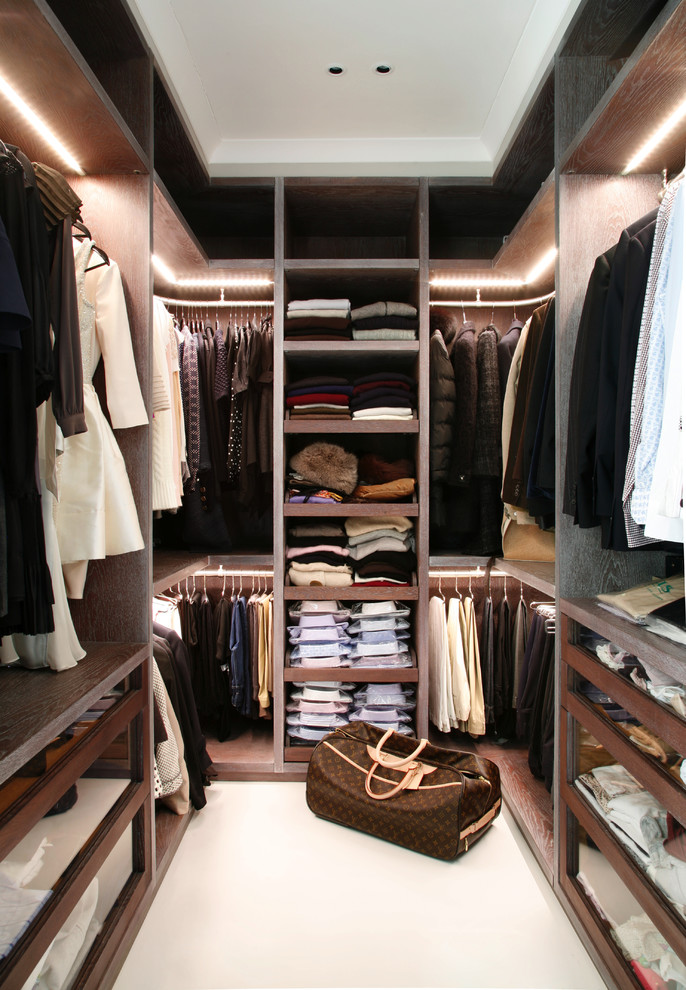 Contemporary storage and wardrobe in London with open cabinets and dark wood cabinets.