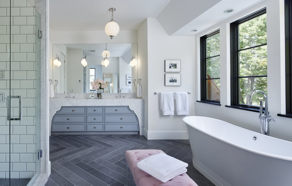 Transitional master bathroom in Minneapolis with flat-panel cabinets, grey cabinets, a freestanding tub, an alcove shower, white tile, white walls, porcelain tile, porcelain floors, an undermount sink and marble benchtops.