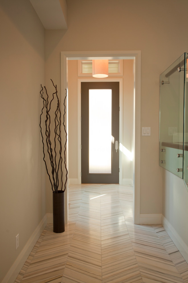 Design ideas for a contemporary hallway in Calgary with beige walls, marble floors and beige floor.