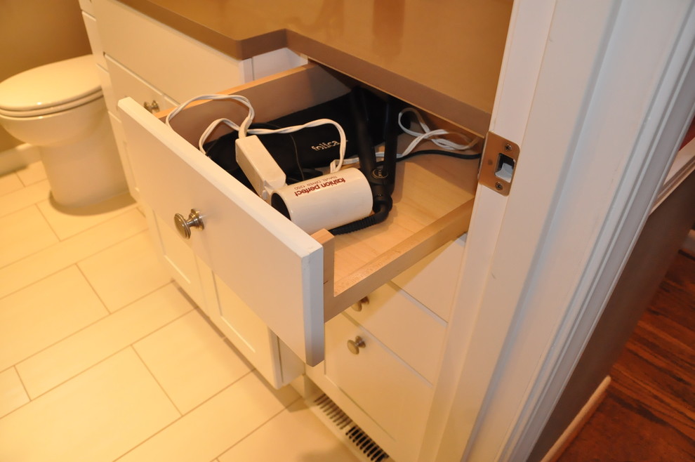 Inspiration for a small transitional 3/4 beige tile and ceramic tile porcelain tile corner shower remodel in Seattle with an undermount sink, recessed-panel cabinets, white cabinets, quartzite countertops, a two-piece toilet and brown walls