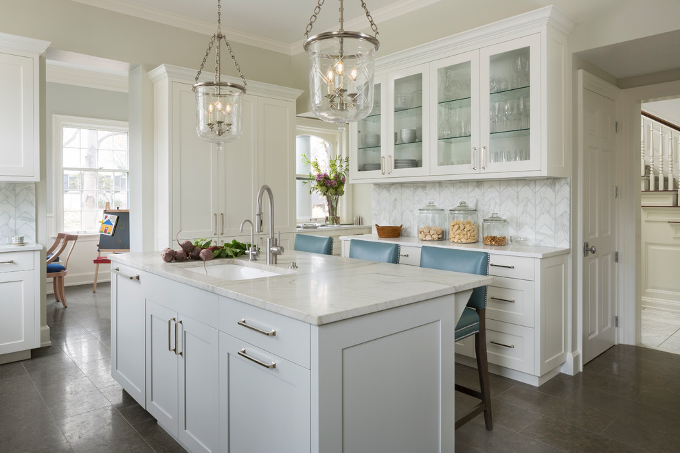 Inspiration for a traditional separate kitchen in Denver with an undermount sink, glass-front cabinets, white cabinets, marble benchtops, white splashback, marble splashback, with island, brown floor and white benchtop.