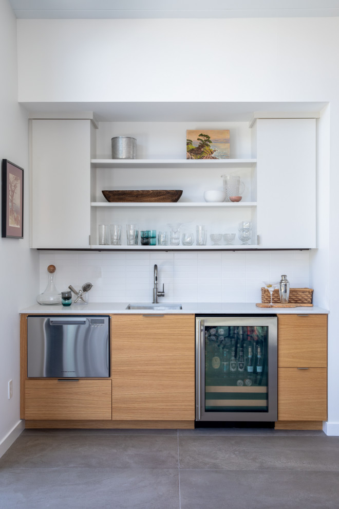Design ideas for a mid-sized midcentury galley eat-in kitchen in San Francisco with a drop-in sink, flat-panel cabinets, light wood cabinets, quartz benchtops, white splashback, ceramic splashback, stainless steel appliances, porcelain floors, with island, grey floor, multi-coloured benchtop and exposed beam.