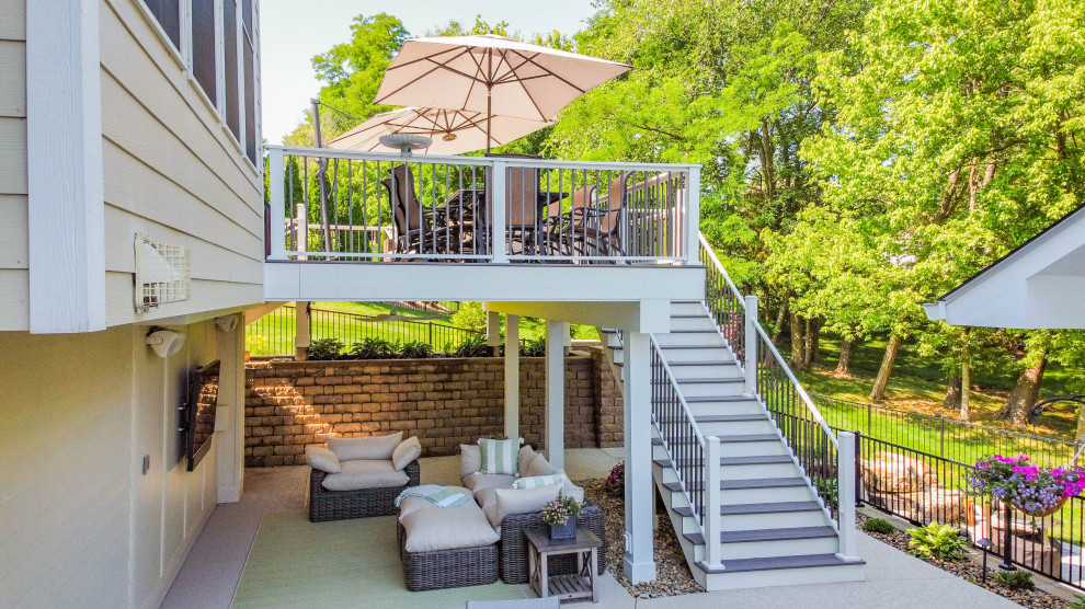 Expansive traditional backyard patio in St Louis with with fireplace, concrete pavers and a gazebo/cabana.