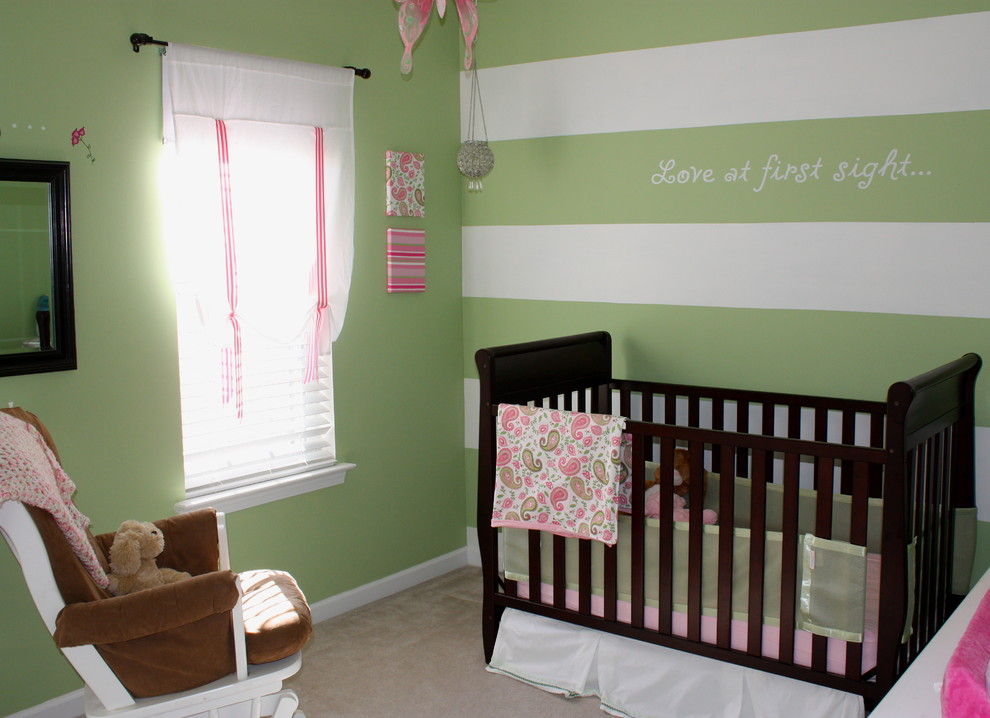Trendy girl carpeted nursery photo in Charlotte with green walls