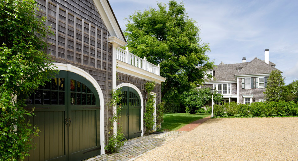 This is an example of a large traditional detached three-car garage in Boston.