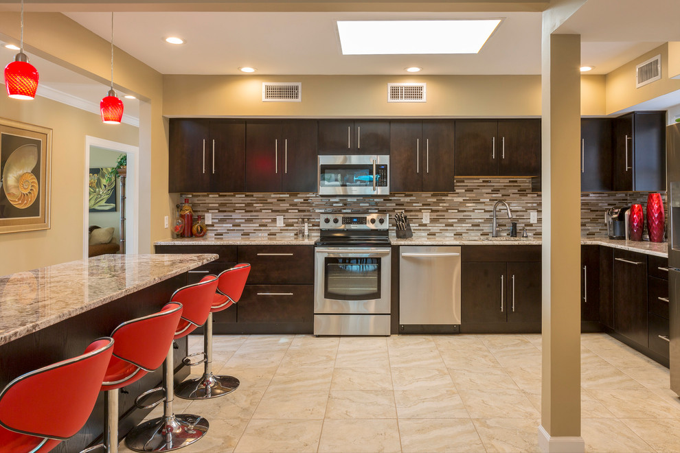 Contemporary kitchen in Tampa with an undermount sink, flat-panel cabinets, dark wood cabinets, brown splashback, matchstick tile splashback, stainless steel appliances, with island, beige floor and brown benchtop.