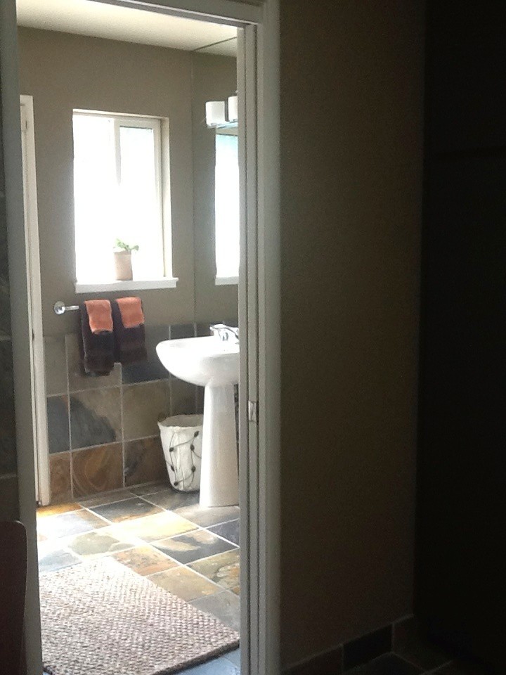 Inspiration for a mid-sized transitional master beige tile, brown tile and travertine tile travertine floor and beige floor bathroom remodel with flat-panel cabinets, dark wood cabinets, beige walls, an undermount sink and quartz countertops