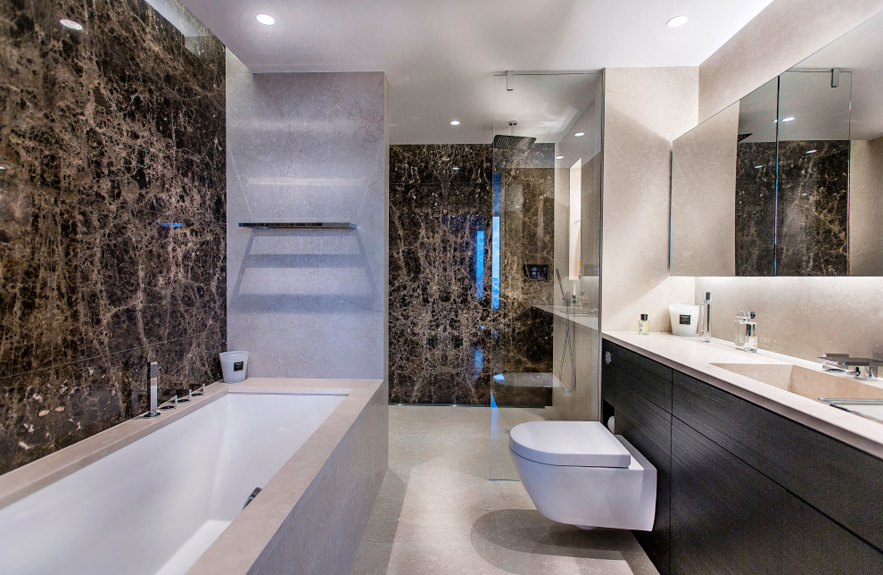 Example of a trendy 3/4 brown tile and ceramic tile ceramic tile, beige floor and single-sink bathroom design in London with flat-panel cabinets, brown cabinets, a wall-mount toilet, beige walls, a drop-in sink, marble countertops, beige countertops and a built-in vanity