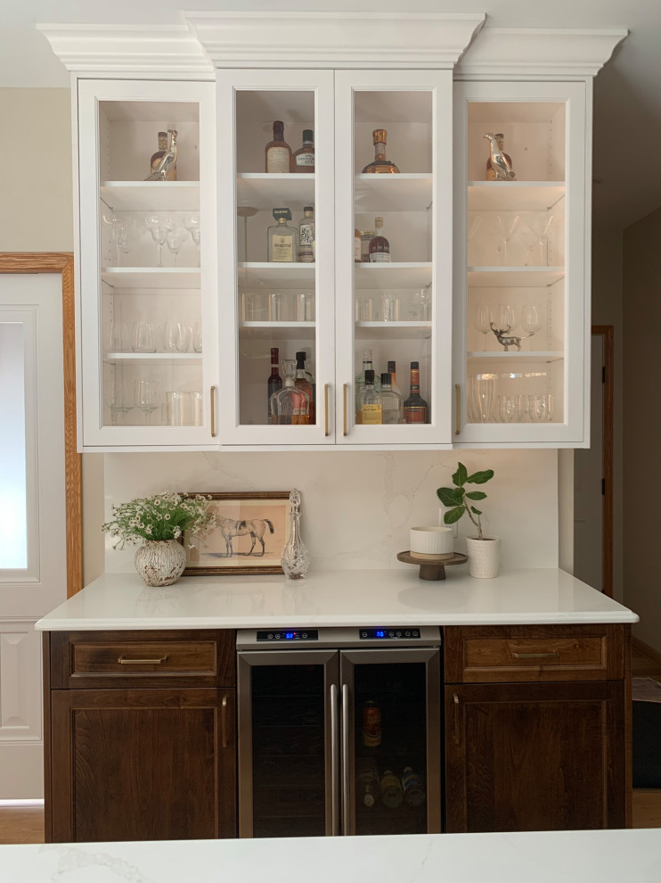 Inspiration for a light wood floor kitchen remodel with a double-bowl sink, shaker cabinets, white cabinets, quartz countertops, quartz backsplash, paneled appliances and an island
