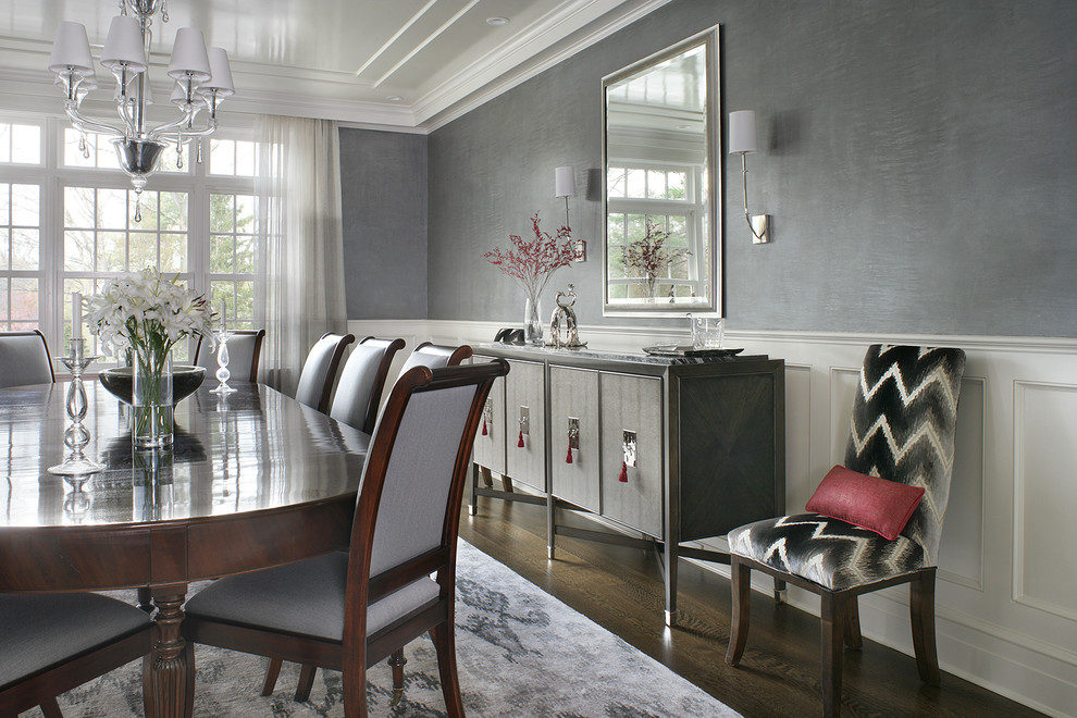 Photo of a large transitional separate dining room in New York with grey walls, dark hardwood floors and brown floor.