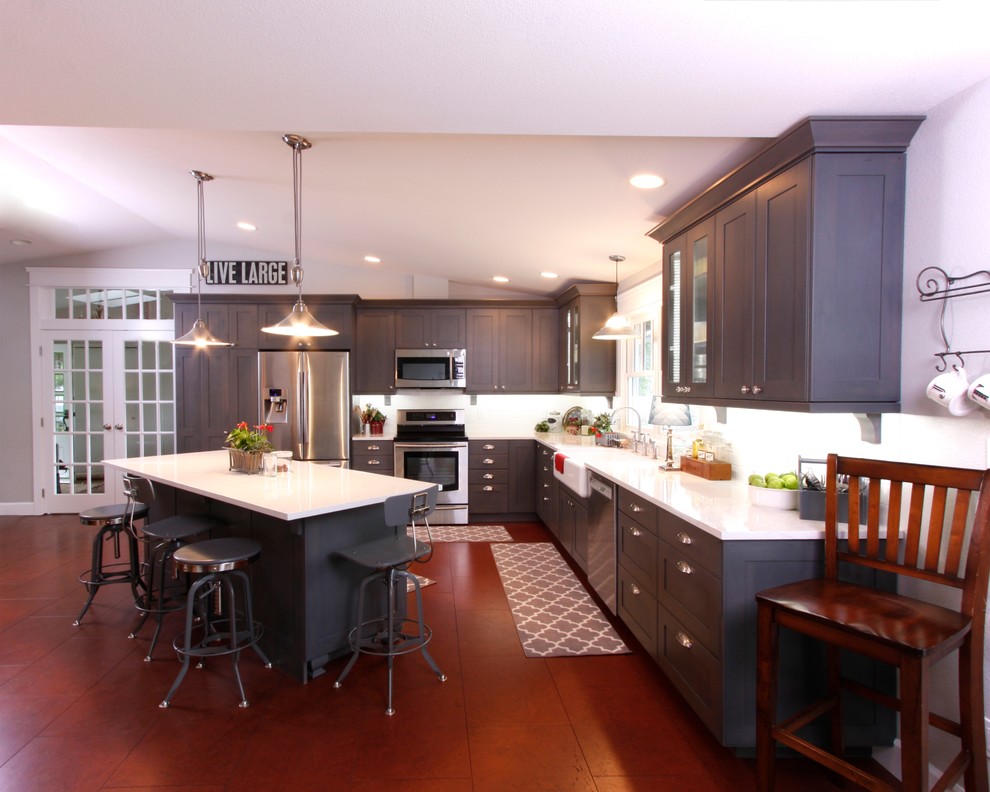 Transitional l-shaped dark wood floor and brown floor eat-in kitchen photo in Seattle with a farmhouse sink, shaker cabinets, gray cabinets, quartzite countertops, stainless steel appliances and an island