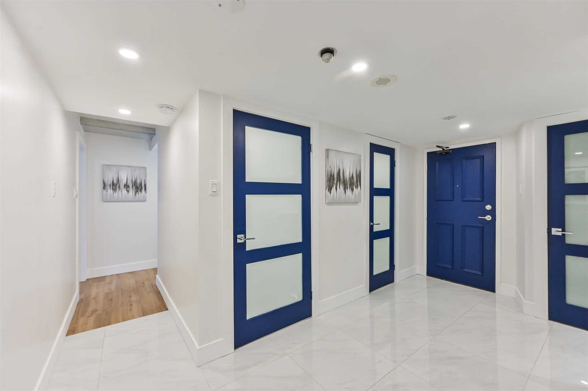 Custom entry way with newly created storage spaces and accented modern french doors