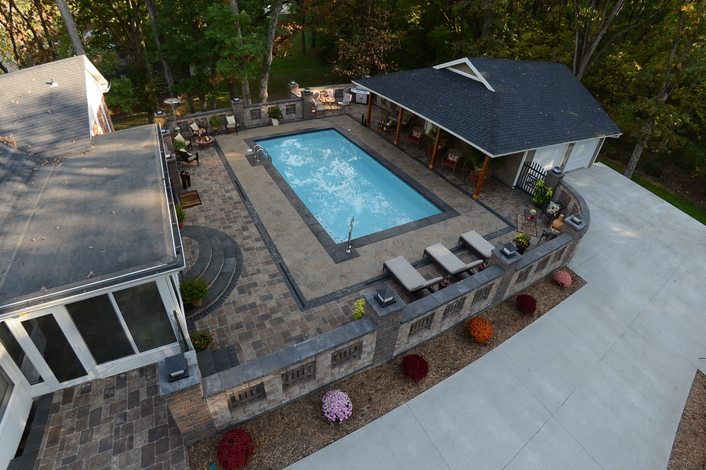 Example of a mountain style backyard concrete paver home design design