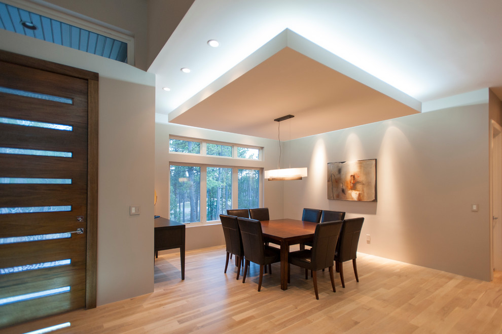 This is an example of a mid-sized contemporary open plan dining in Denver with light hardwood floors, grey walls, no fireplace and beige floor.